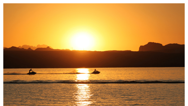 People on Lake Havasu riding jet skis during sunset