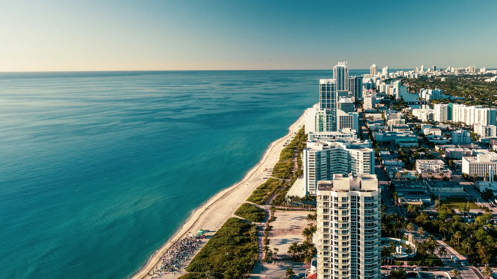 High up view of Miami shoreline with buildings and people