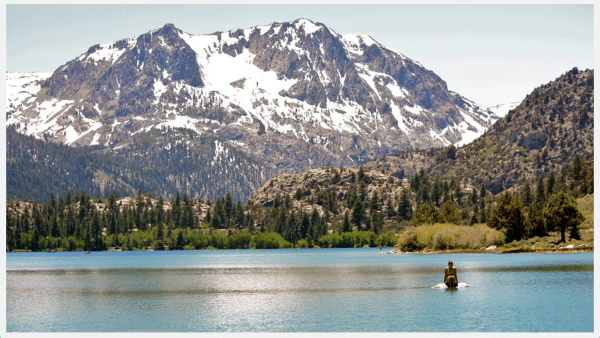 Lake view of Mammoth Lakes and woman swimming