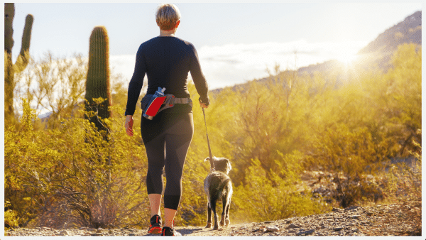 Woman with dog hiking trail phoenix arizona