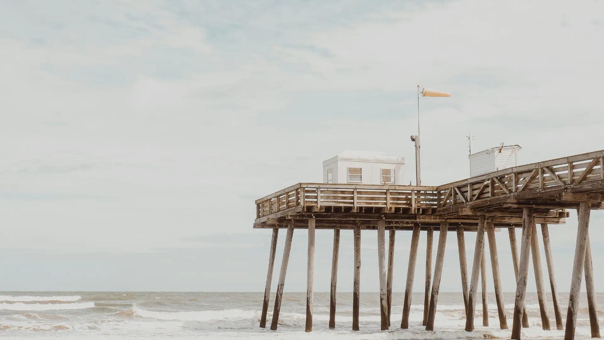 A wooden pier extending over the ocean in Ocean City