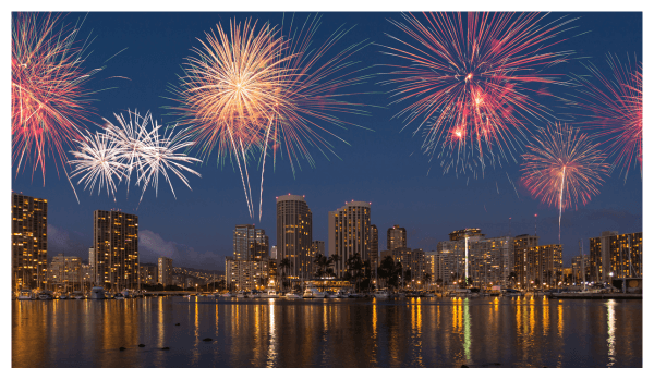 Nighttime image of fireworks over Honolulu city skyline