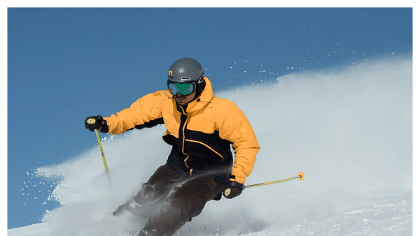 Image of person skiing in a yellow jacket