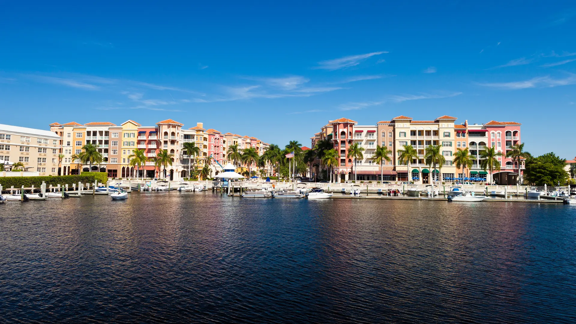 View of colorful buildings and waterfront in Naples, FL