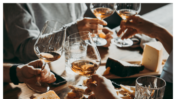 Image of people doing a cheers at a wine bar