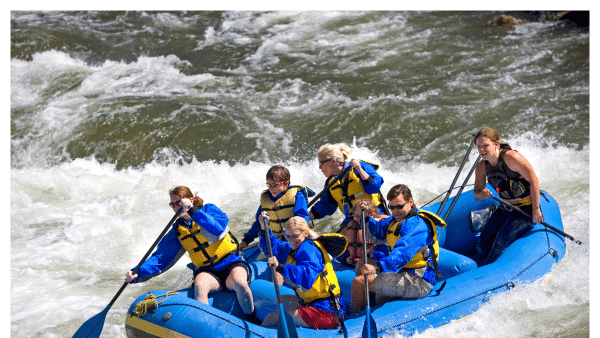 Image of people in a white water raft on River