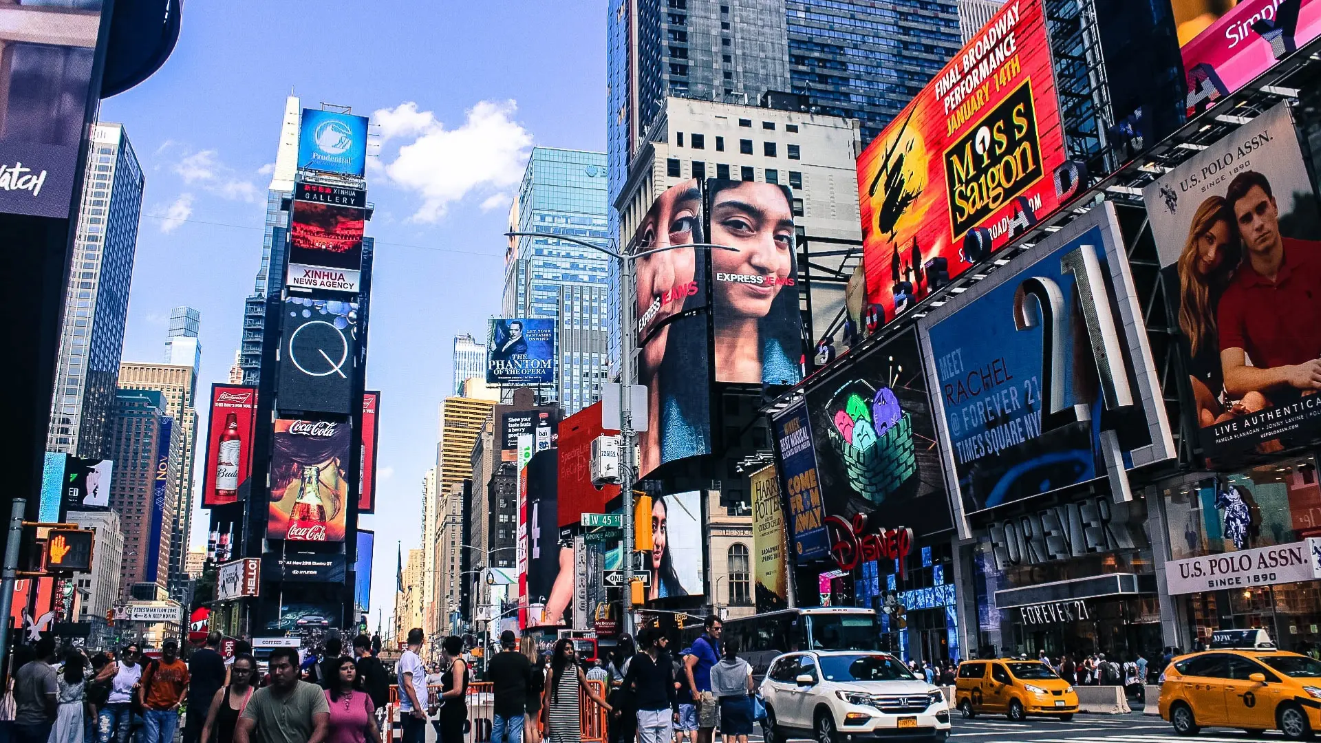 Photo of times square with all the hustle and bustle of people and cars