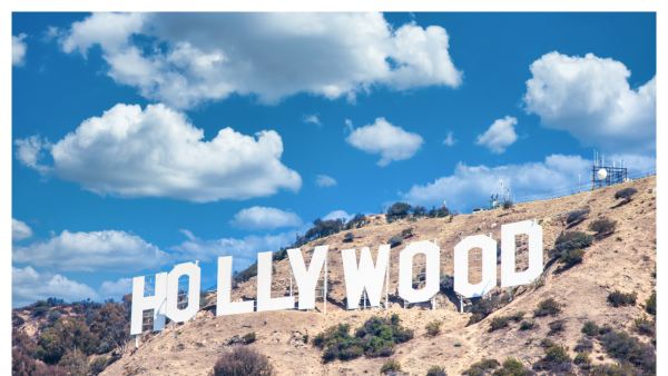 VIew of the Hollywood sign in LA on a blue sky day with scattered clouds