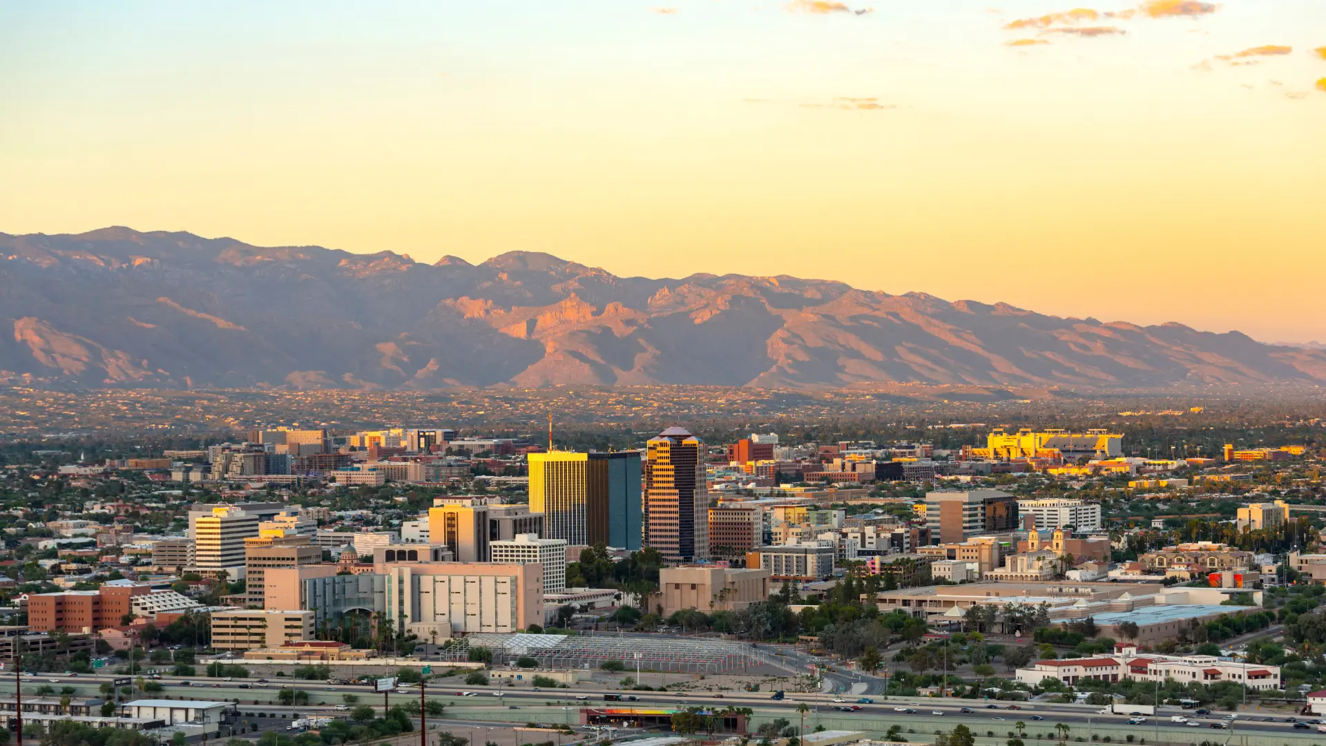 View of Tucson Arizona skyline during sunset with highway in the foreground