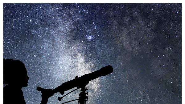 Silhouette image of woman stargazing with telescope at night