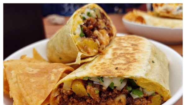 View of burrito and chips on a plate from Mony's