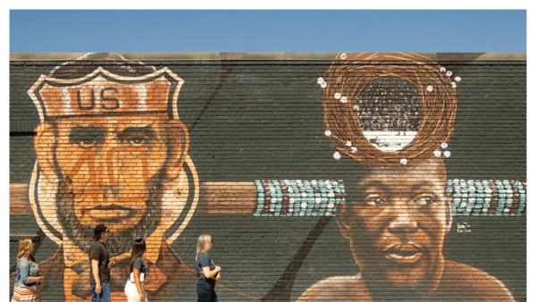 View of people admiring the street art on a brick wall in Reno