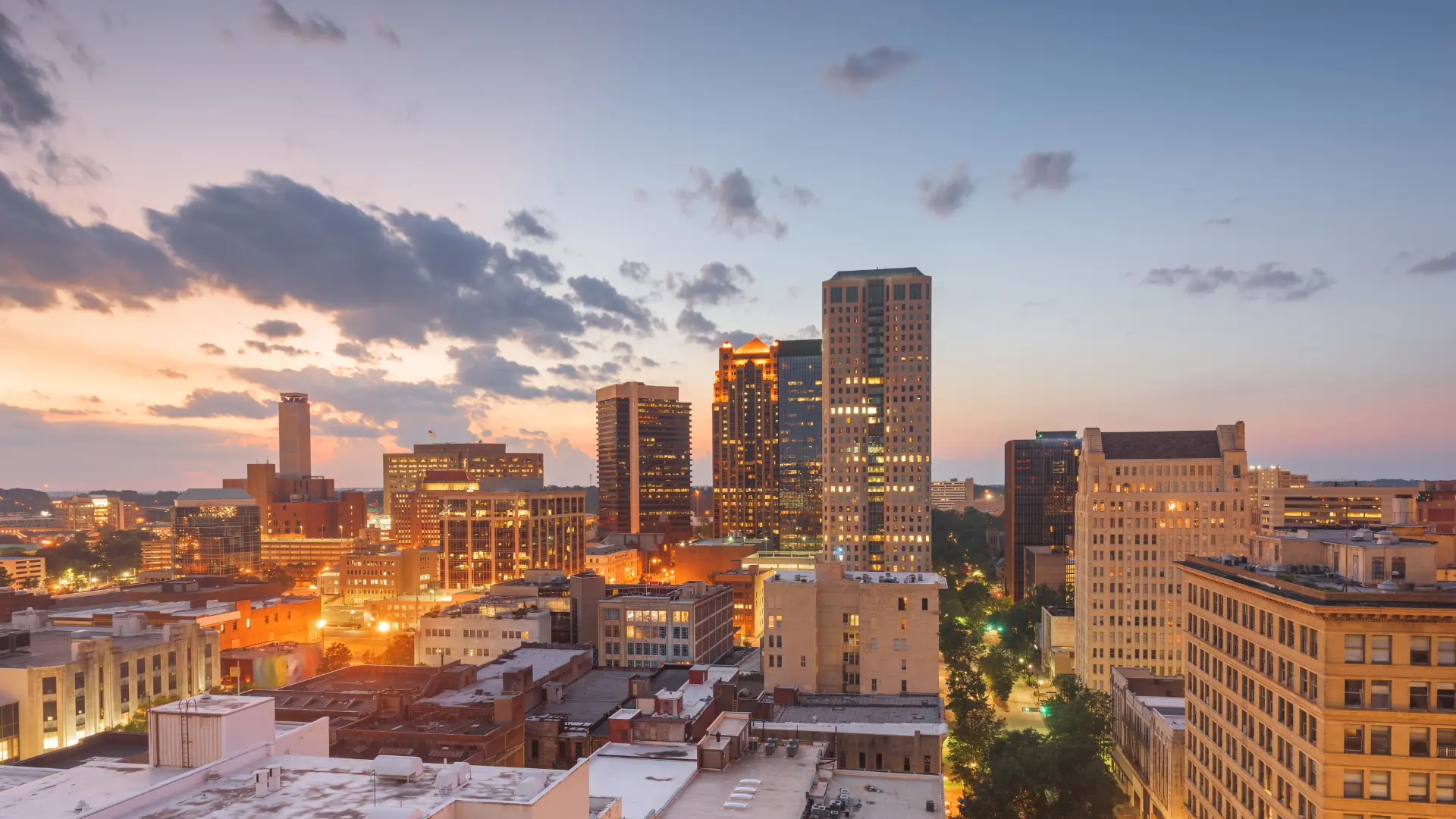 Aerial view of downtown Birmingham at sunset with tall buildings