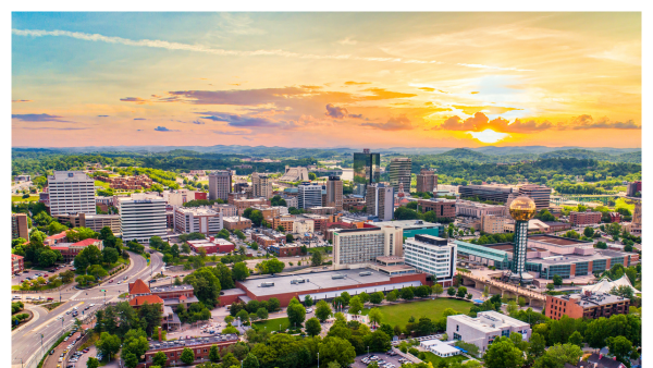 Aerial view of downtown Knoxville skyline with the sun in the background