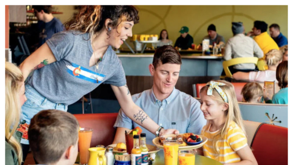 View of people getting served breakfast at Snooze AM eatery