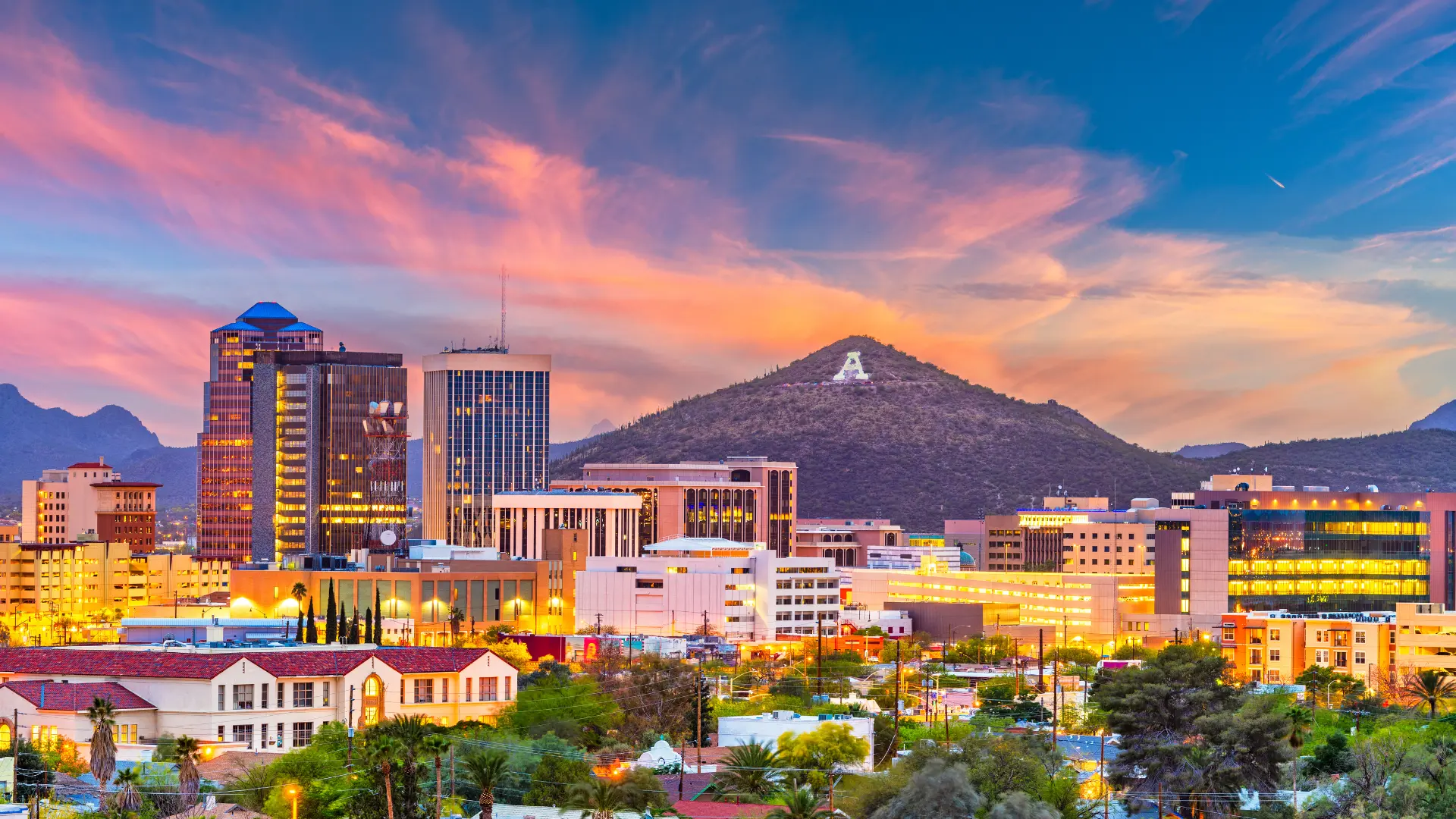 View of the Tucson Arizona skyline at sunset and mountains in the background