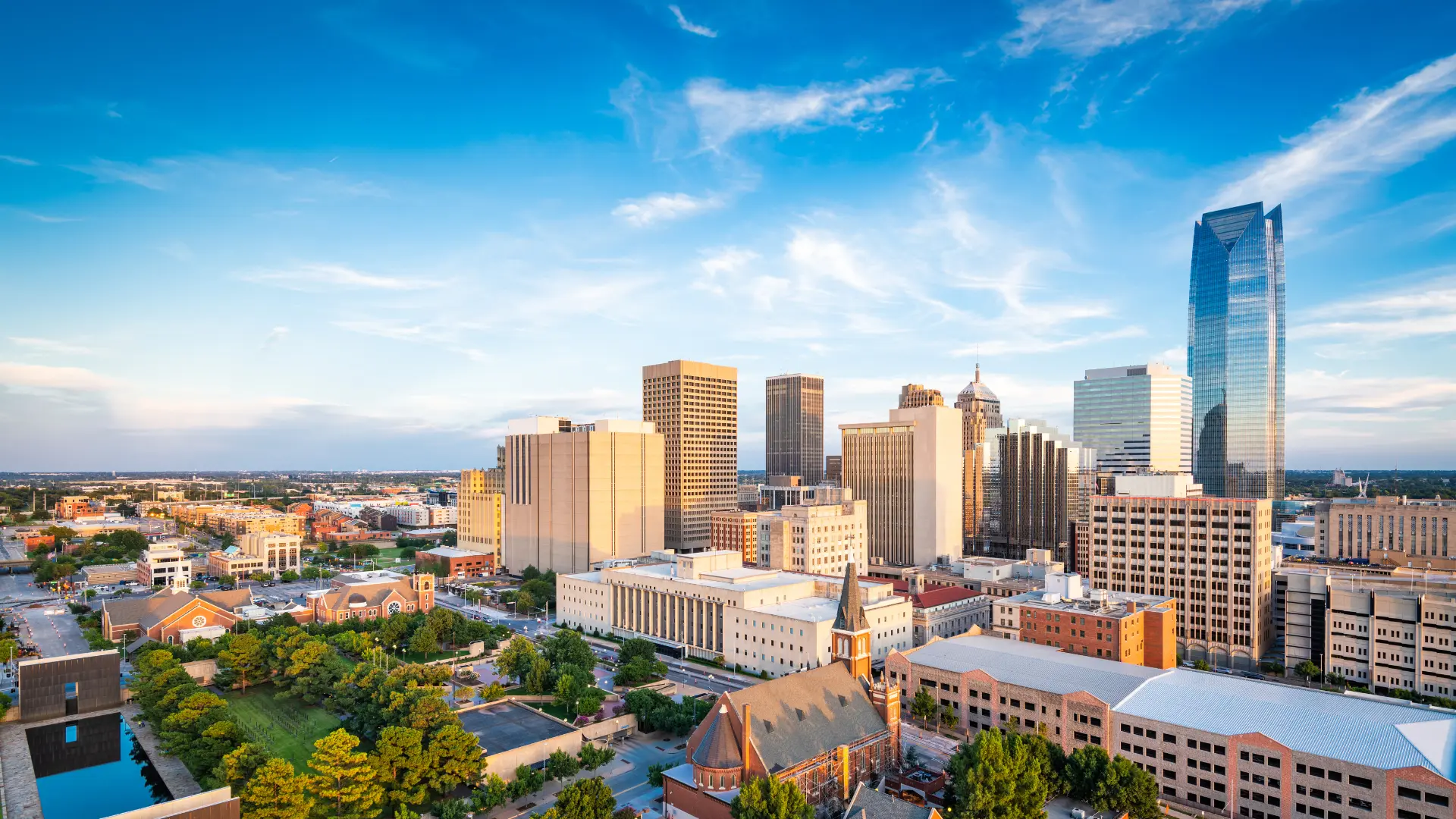 Aerial view of the Oklahoma City skyline with clouds and tall buildings