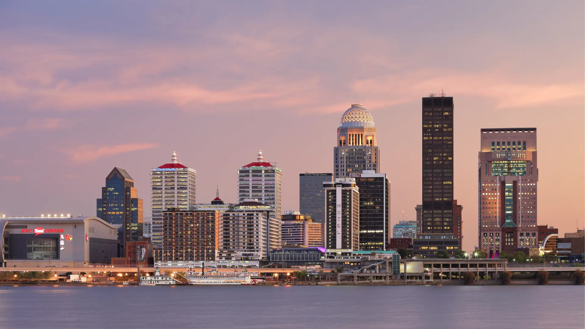 View of the Louisville skyline during sunset with river in the foreground